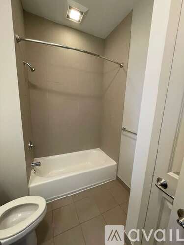 A bathroom with a toilet, tub, and shower.