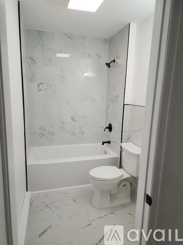 A bathroom with a toilet and a bathtub.