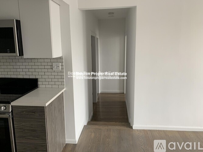 A kitchen area with a stove and a microwave.