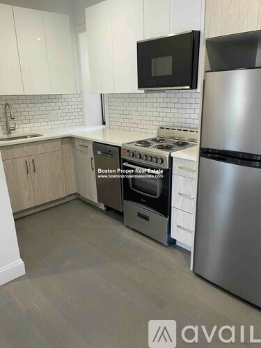 A kitchen with a stove, oven, and refrigerator.