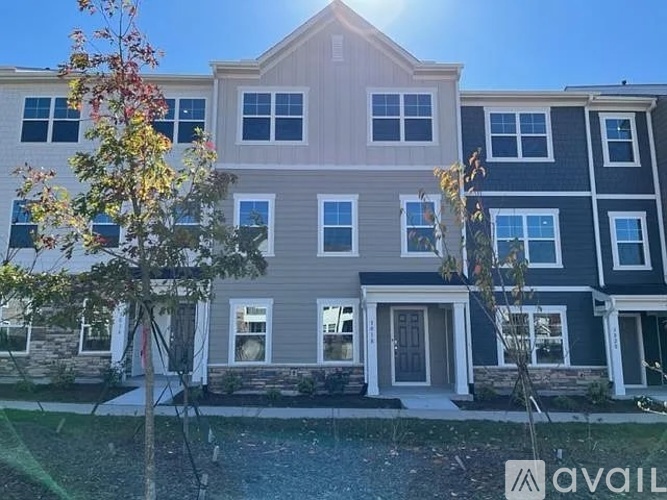 A row of townhouses with a sign that says "available" in front of them.