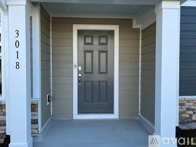 A grey door with a white frame is the main focus of the image.