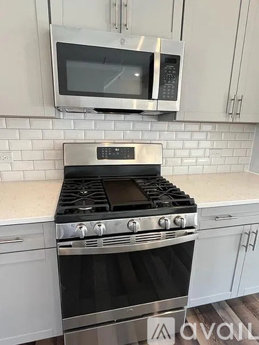 A stainless steel oven with a microwave above it in a kitchen.
