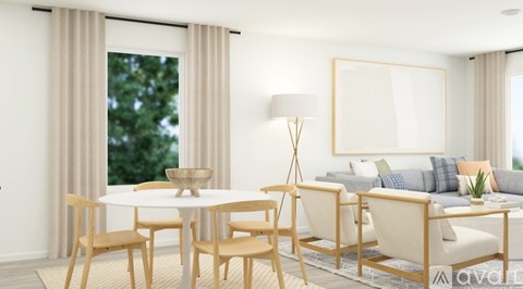 A modern living room with a dining table and chairs.