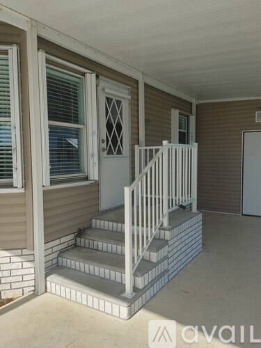 A small house with a staircase leading to the second floor.