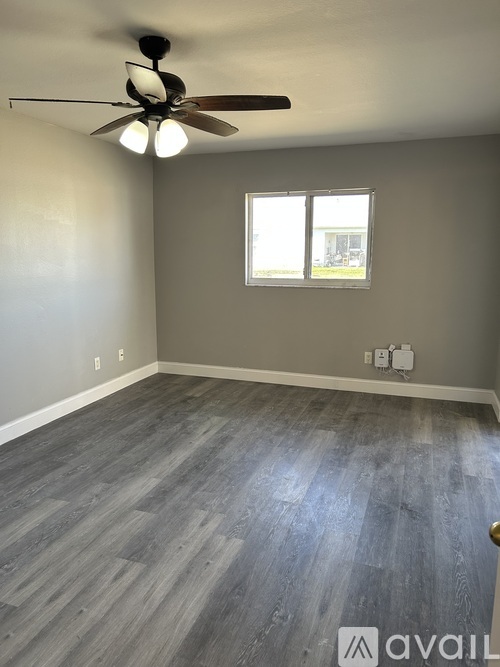 A room with a ceiling fan and a window.