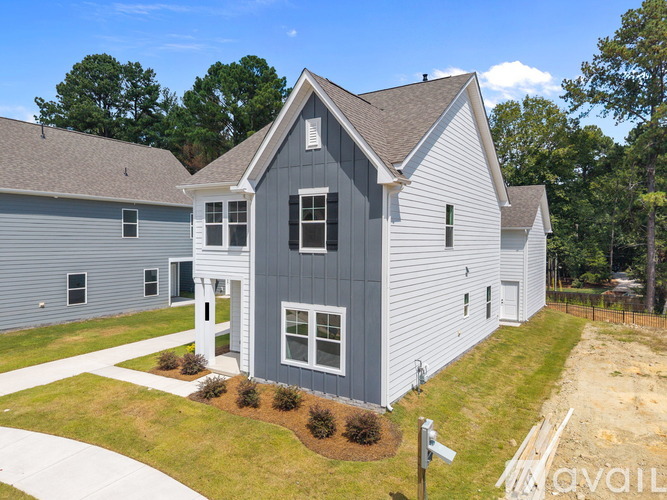 A grey house with a white door and windows.