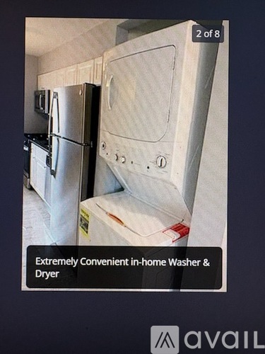 A white washer and dryer in a kitchen.