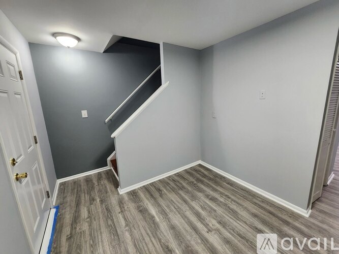 A room with a staircase leading to the upper floor.