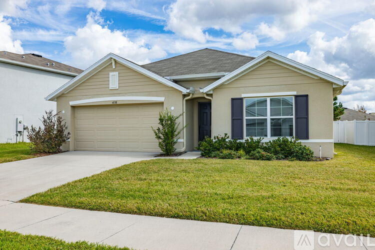A house with a garage and a driveway in front.