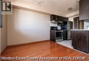 A kitchen with wooden floors and stainless steel appliances.