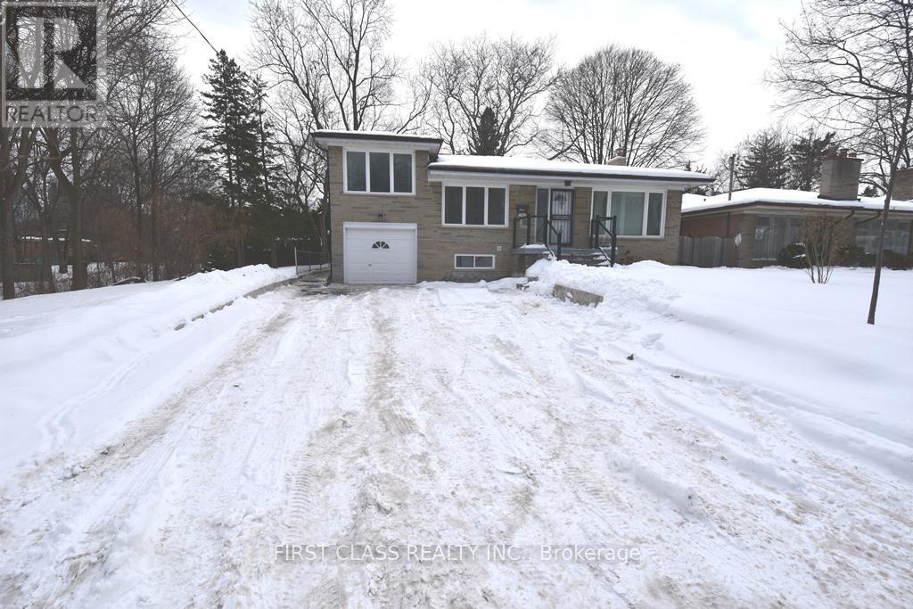A snow-covered house with a sign that says "REALTOR" in the background.