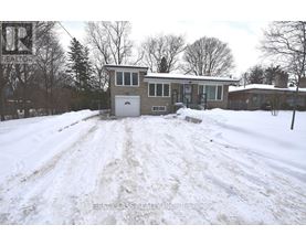 A snow-covered house with a sign that says "REALTOR" in the background.
