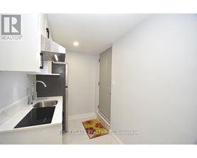 A small kitchen with a sink and a refrigerator.