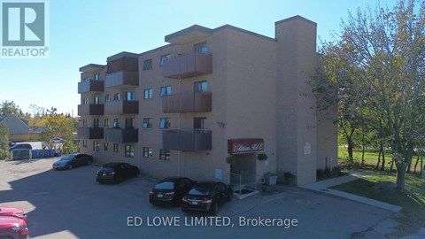 A building with the text "ED LOWE LIMITED, Brokerage" on the front.