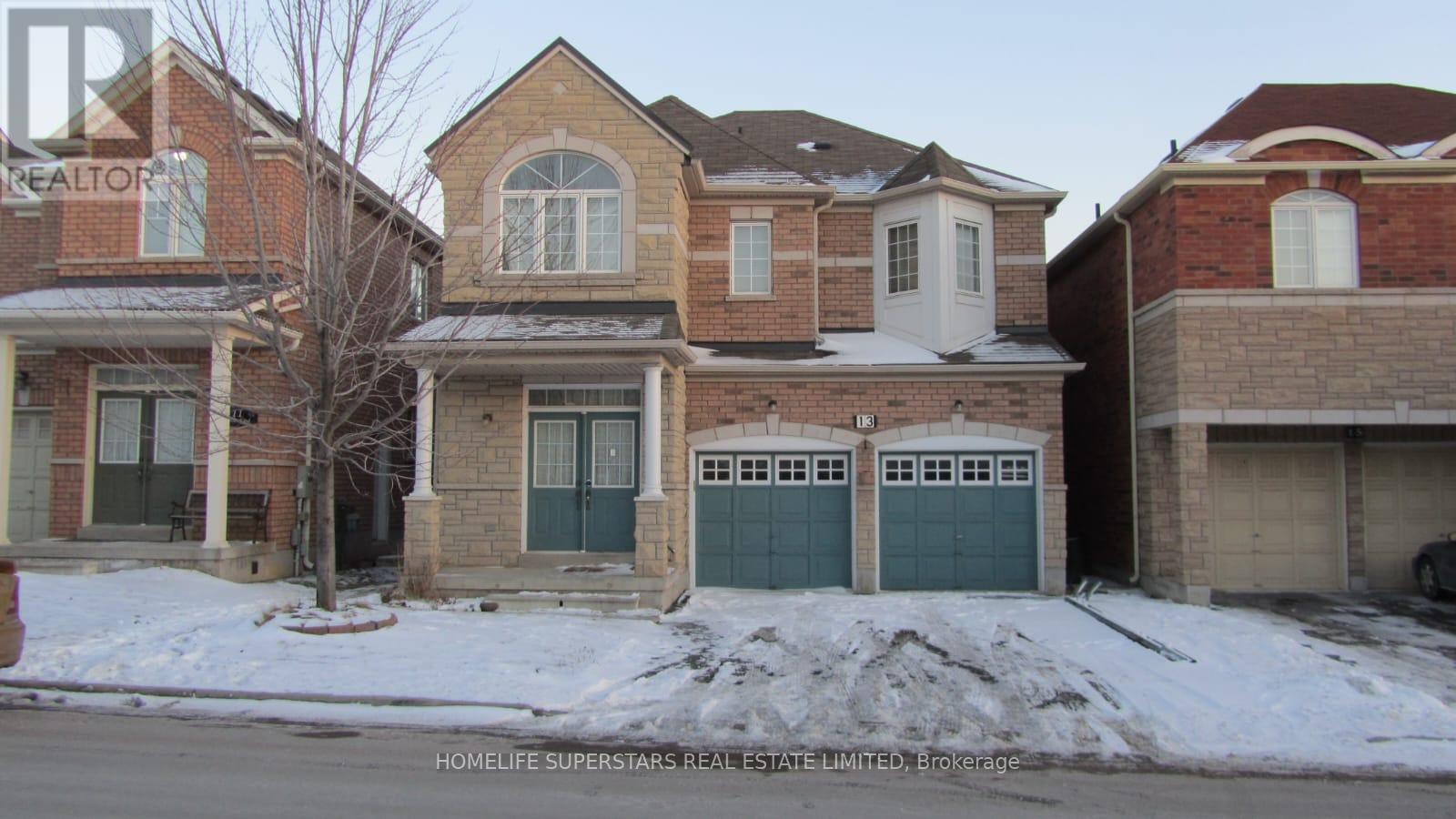 A row of houses with garages in front.