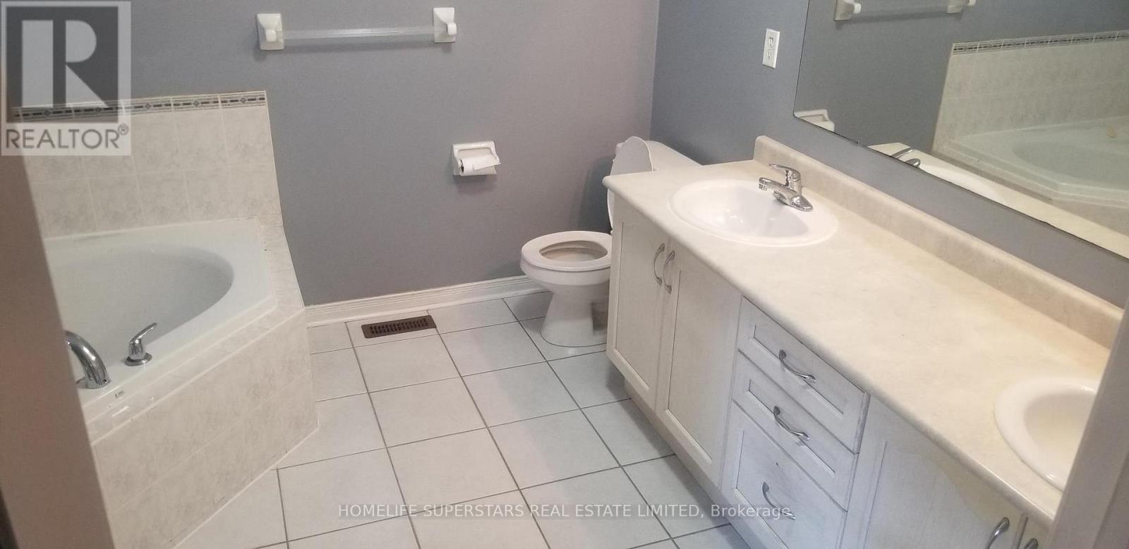 A bathroom with a sink, toilet, and bathtub.