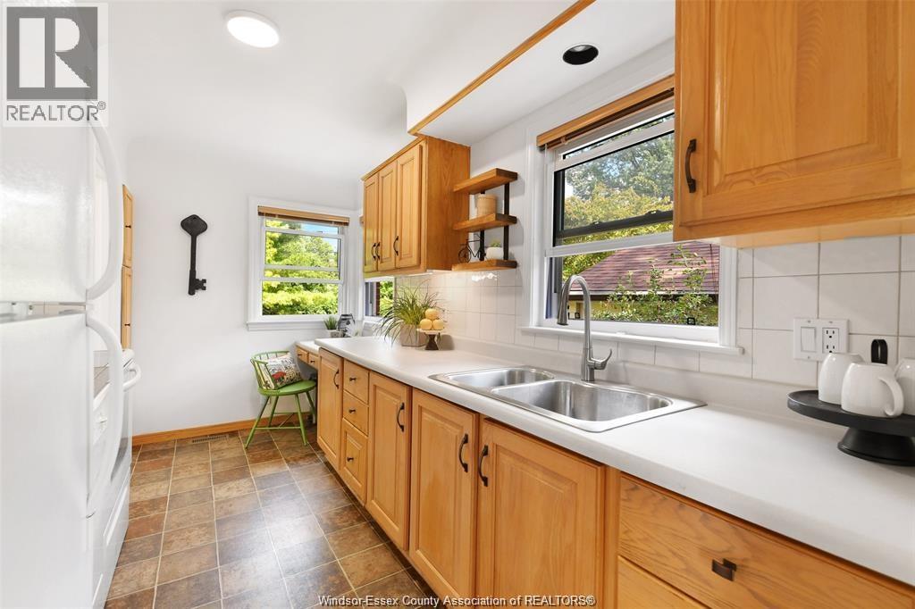 A kitchen with wooden cabinets and a white refrigerator.