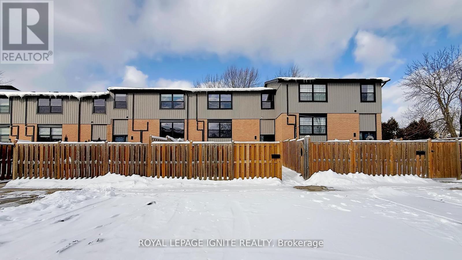 A building with a fence in front of it is for sale.