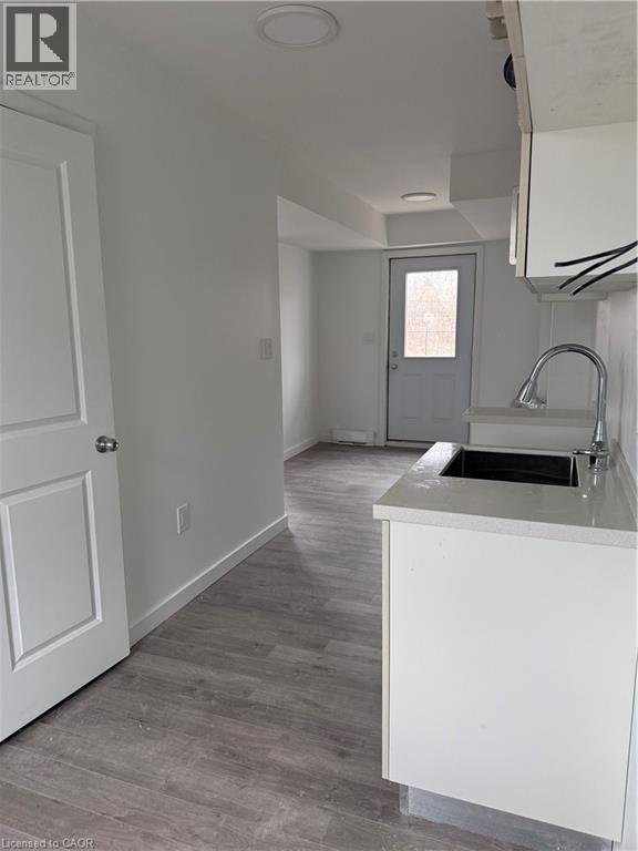 A kitchen with a sink and a door.