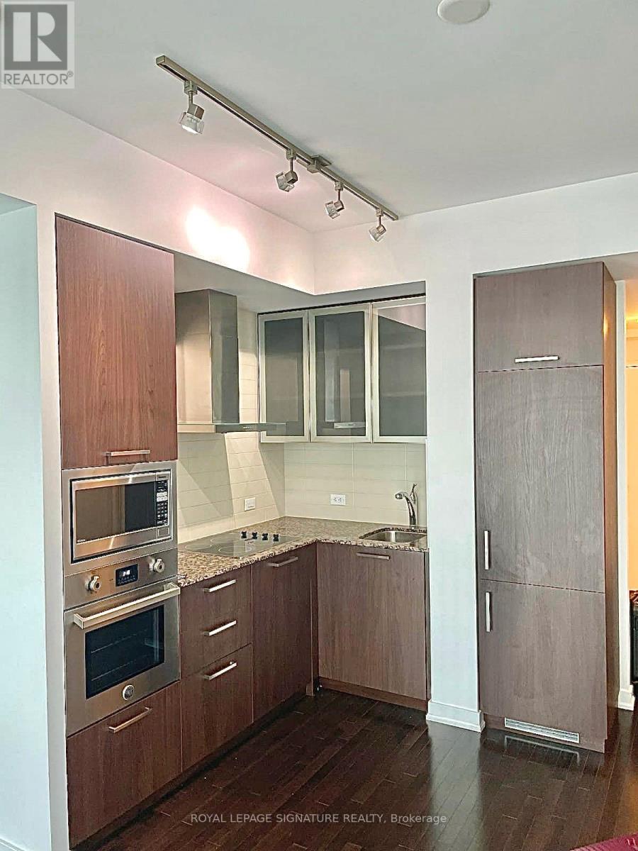 A kitchen with wooden cabinets and stainless steel appliances.