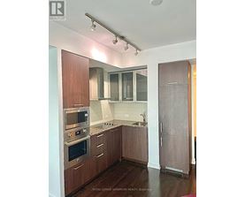 A kitchen with wooden cabinets and stainless steel appliances.