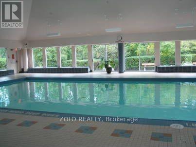 A pool inside a building with the logo of Zolo Realty, Brokerage on the bottom.