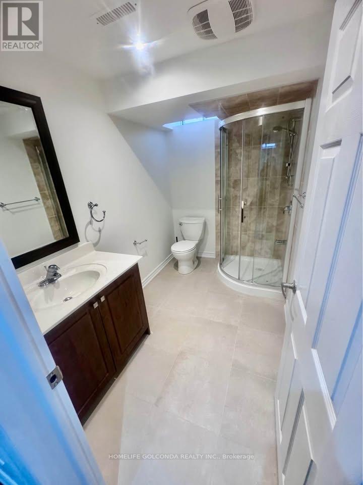 A bathroom with a sink, toilet, and shower.