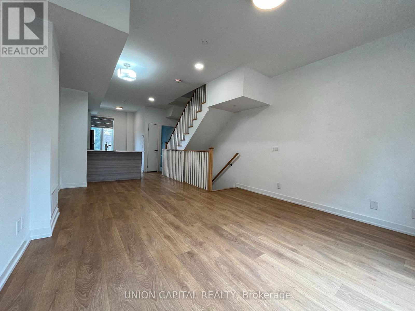 A staircase with wooden steps and white walls.