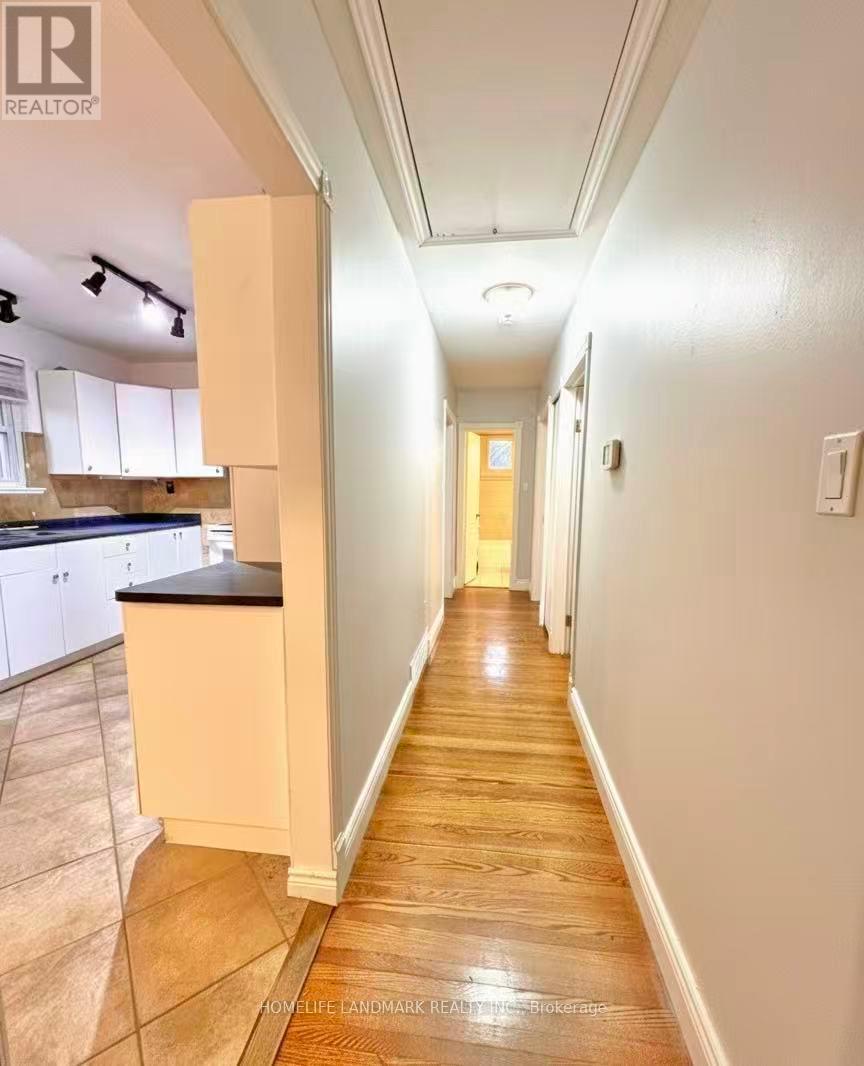 A long hallway with a kitchen area on the left.