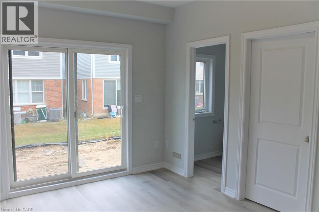 A room with a sliding glass door leading to a construction site.