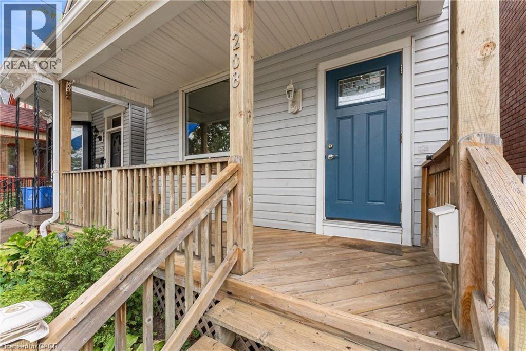 A house with a blue door and a wooden porch.