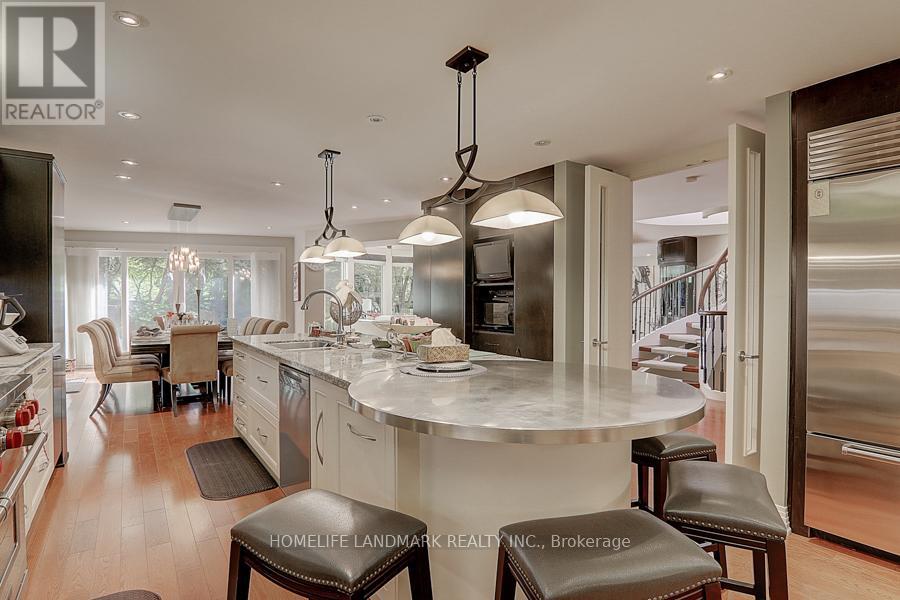 A modern kitchen with a large island and bar stools.