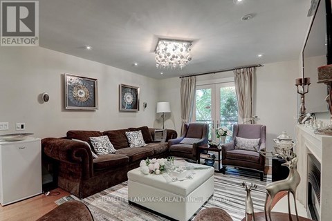 A living room with a brown couch and a white coffee table.
