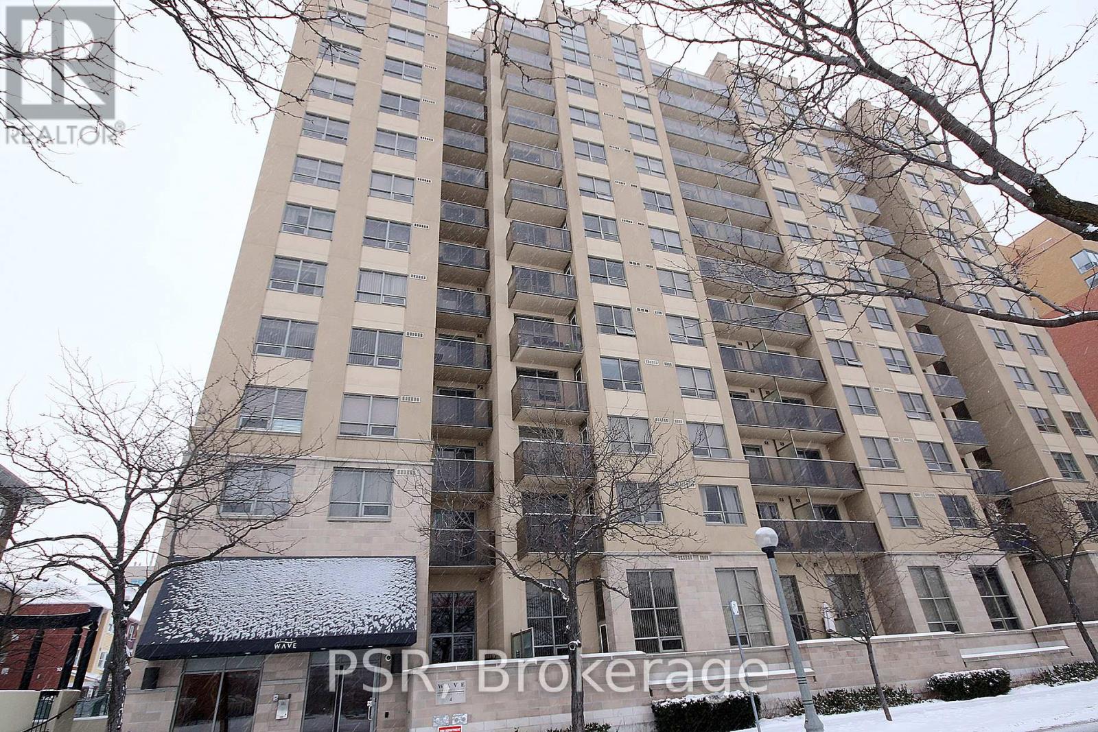 A tall residential building with a balcony on the second floor from the front.