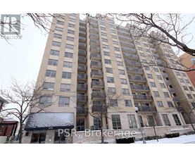 A tall residential building with a balcony on the second floor from the front.