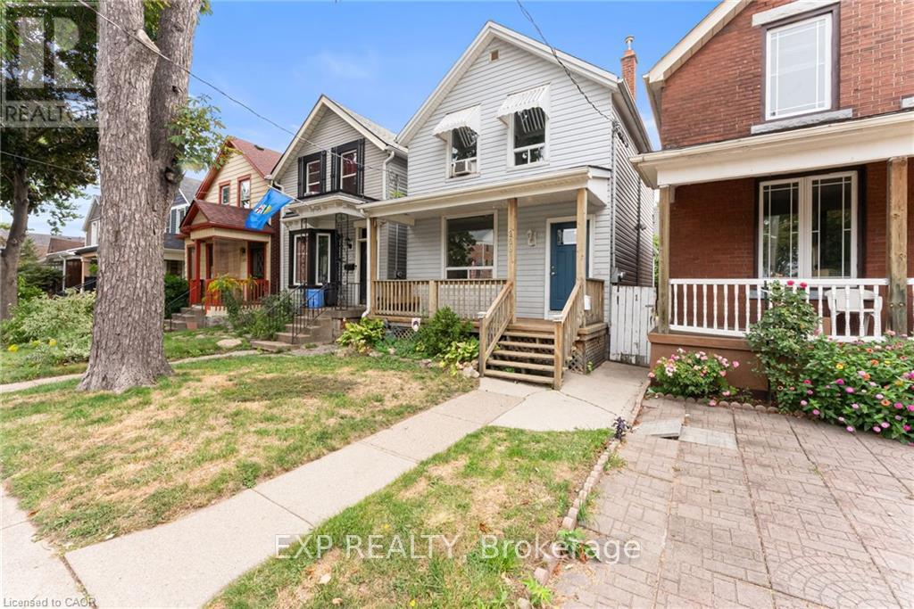A house with a blue door and a porch with a railing.
