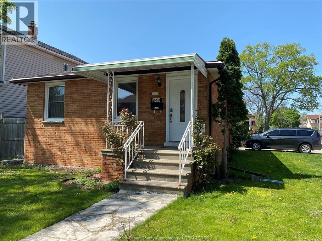 A small brick house with a white door and a small porch.