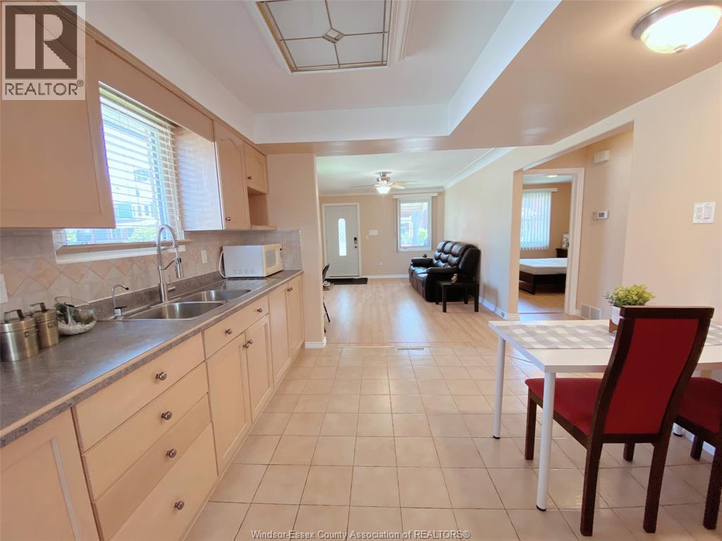 A kitchen with a table and chairs in the middle of the room.