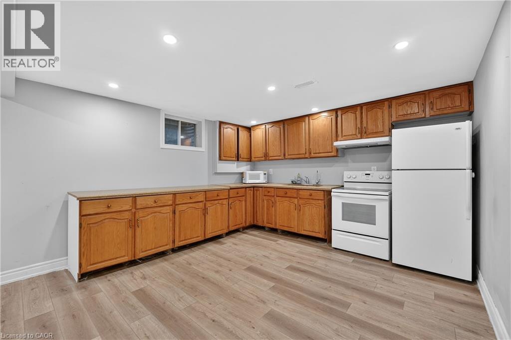 A kitchen with wooden cabinets and a white refrigerator.