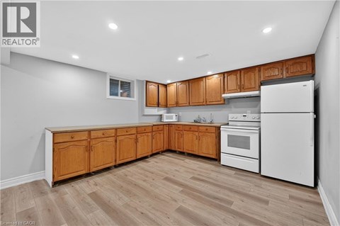 A kitchen with wooden cabinets and a white refrigerator.