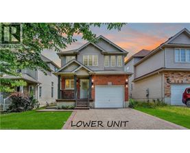 A house with a driveway in front and a sign that says "LOWER UNIT".