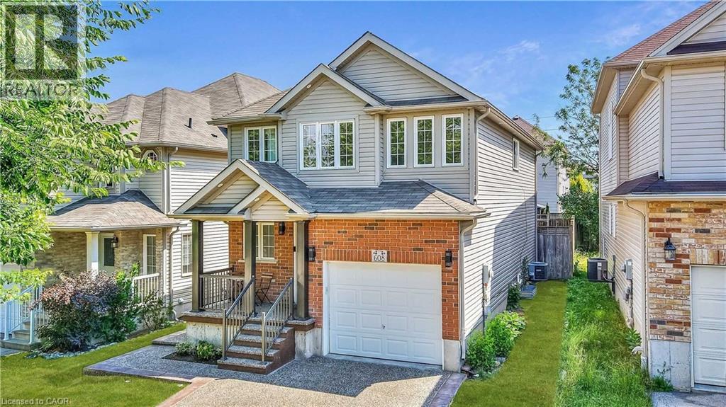 A house with a grey roof and a white garage door.