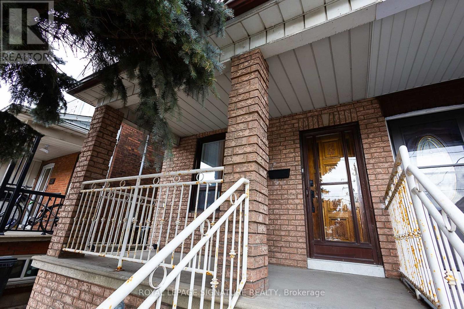 A house with a balcony and a door is shown.