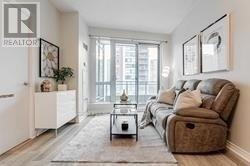 A living room with a brown couch and a coffee table.