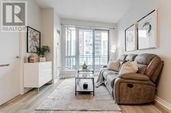 A living room with a brown couch and a coffee table.
