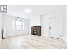 A white room with a fireplace and a window.