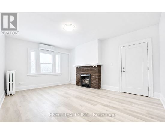 A white room with a fireplace and a window.