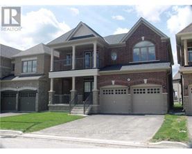 A large brick house with a garage is for sale.