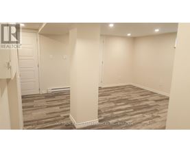 A room with a wooden floor and white walls.